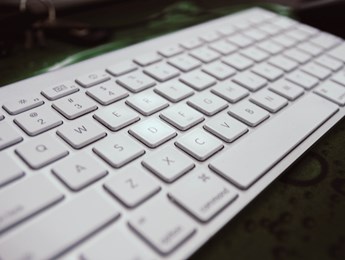 Image of a white computer keyboard on a black background