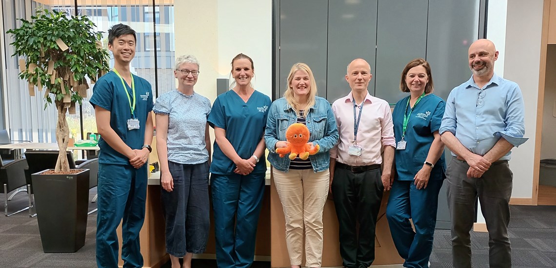 Image of Anne Rowling Regenerative Neurology clinic (Edinburgh) study staff standing together with octopus (mascot) plushie